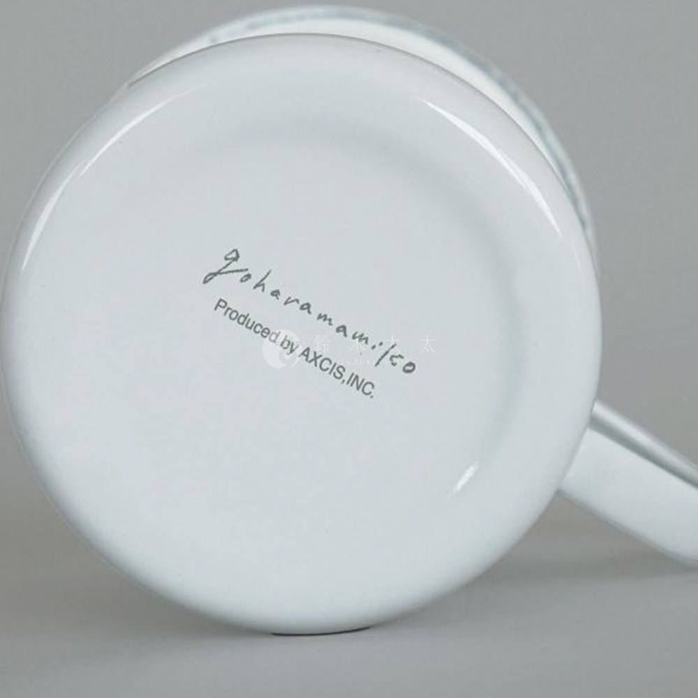 白色琺瑯馬克杯底部，有黑色手寫字體「Goharamamiko」和「Produced by AXCIS, INC.」字樣。