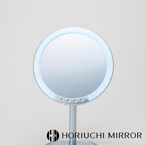 銀色金屬材質的圓形化妝鏡，鏡面周圍有環狀LED燈，下方設有四個圓形按鈕。