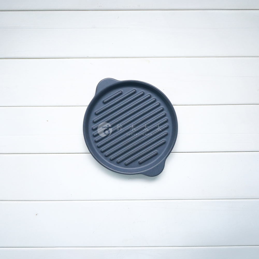 The chef 多功能耐熱陶製萬用波浪圓烤盤 S，呈現深藍色，圓形盤面帶有平行凸起的烤紋，兩側有小巧的提把。