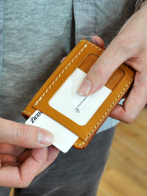 職人手作皮革三面雙折票券收納夾，採用經典咖啡色皮革，車縫線清晰，設有透明票夾，可放入票卡，方便取用。