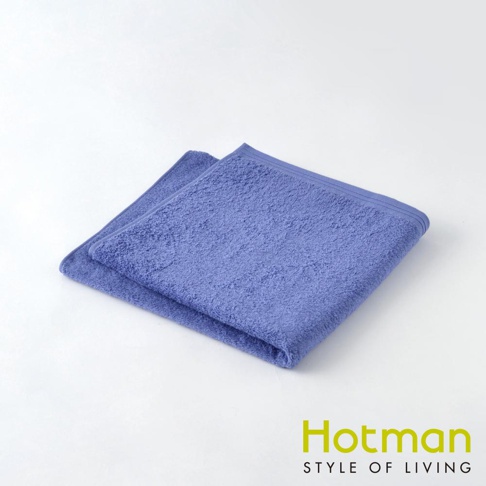 一條淺紫色、觸感柔軟的毛巾，材質為棉，邊緣有雙層縫線，呈現簡約設計。