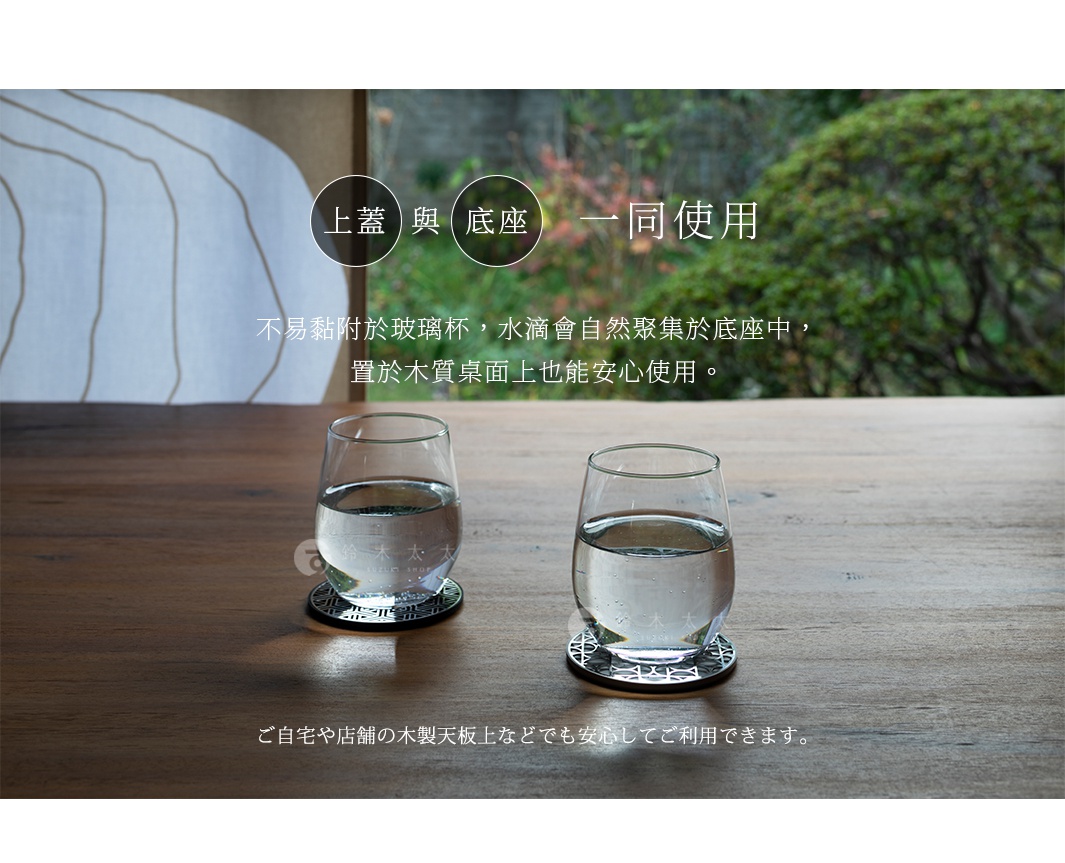 圖片文字：上蓋與底座一同使用。不易黏附於玻璃杯，水滴會自然聚集於底座中，置於木質桌面上也能安心使用。ご自宅や店舗の木製天板上などでも安心してご利用できます。兩只透明玻璃杯分別放置在精緻的金屬鏤空杯墊上，杯墊表面呈現幾何紋理，整體擺放在溫潤的深色木質桌面，背景為模糊的庭院綠意，營造出寧靜雅緻的居家氛圍。