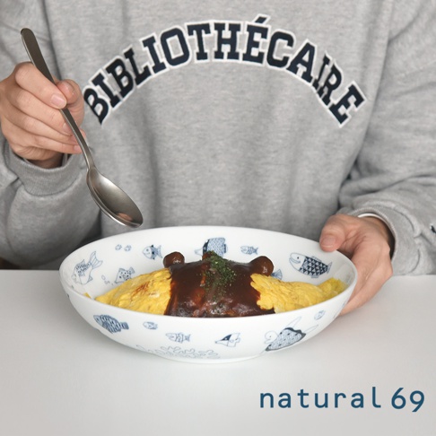 cocomarine大圓深碗，白色陶瓷碗內繪有藍色小魚圖案，盛有蛋包飯，飯上淋有深褐色醬汁，並撒有綠色香料。