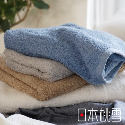 堆疊的飯店大毛巾，顏色從上至下為淺藍、淺灰、卡其色、白色及深灰色，皆為純色，材質看起來是柔軟的毛圈織物。