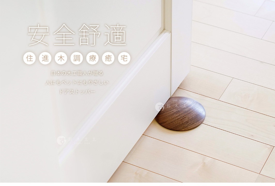 天然實木製的半圓形門擋，木紋清晰，深棕色，放置於白色門與淺木色地板之間。