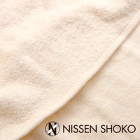米白色毛巾布質地的枕套，織紋清晰，材質柔軟，邊緣有車縫線，右下角有「NISSEN SHOKO」品牌標誌。