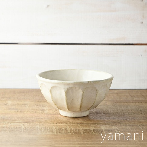 一個米白色、帶有六道凹槽紋路的陶瓷丼碗，碗底有小型的座台，整體呈現樸實的手感質感。