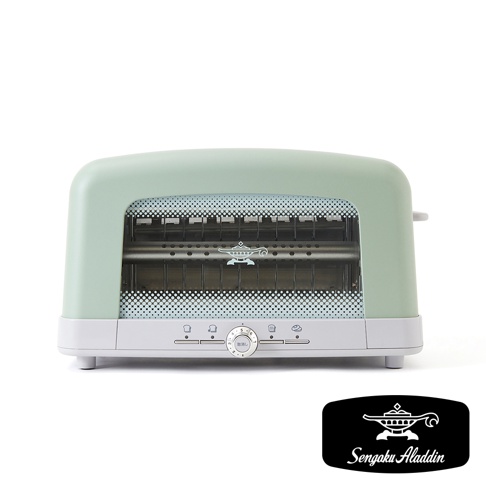 淺綠色烤麵包機，設有透明玻璃視窗，內部有烤架及阿拉丁神燈標誌。機身下方有白色面板，上面有幾個圖示按鈕和一個圓形旋鈕，旋鈕上標有數字 1 至 6。