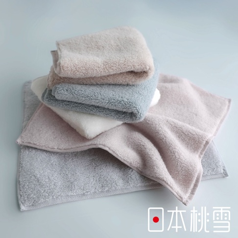 日本桃雪今治棉蕾超無撚蓬鬆毛巾，堆疊展示，包含粉色、灰色、白色和淺藍色等多種柔和色調，觸感蓬鬆柔軟。