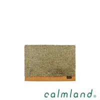 Ward Robe S 尺寸的玄關地墊，以橄欖綠的長毛絨材質製成，底部邊緣為棕色皮革，整體呈現簡約風格。