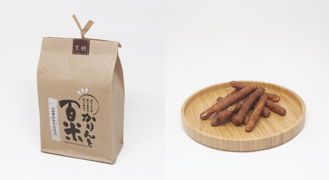 左側為牛皮紙包裝袋，上面印有黑色和白色的日文標籤。右側為淺色木製圓盤，上面堆疊著幾根深棕色的條狀餅乾。