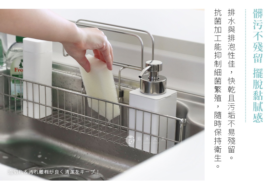 一隻手正將乾爽的白色海綿放入水槽金屬瀝水架，旁邊有洗碗精瓶和皂液器，右側有中文標語。