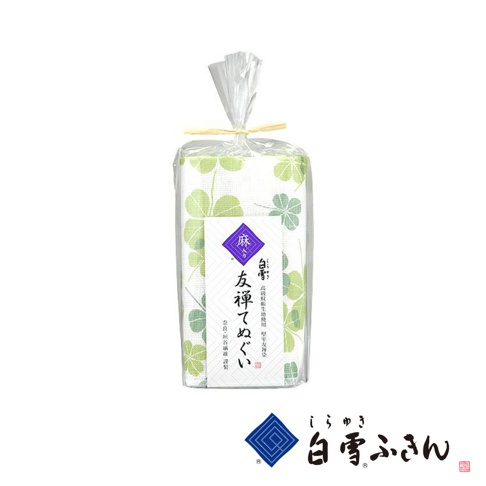友禪染廚房兩用長拭巾，白色底布印有淺綠色四葉草圖案，以透明塑膠袋包裝，頂部以麻繩捆綁。