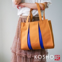 京都職人手作ougi棉帆布扇形托特包，以橘棕色棉帆布為主體，搭配鮮豔的藍色內襯，扇形設計獨特，簡約實用。