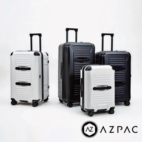 四個 AZPAC Trucker 旅行箱，兩個白色，兩個黑色，皆為硬殼材質，配備可伸縮拉桿和萬向輪。
