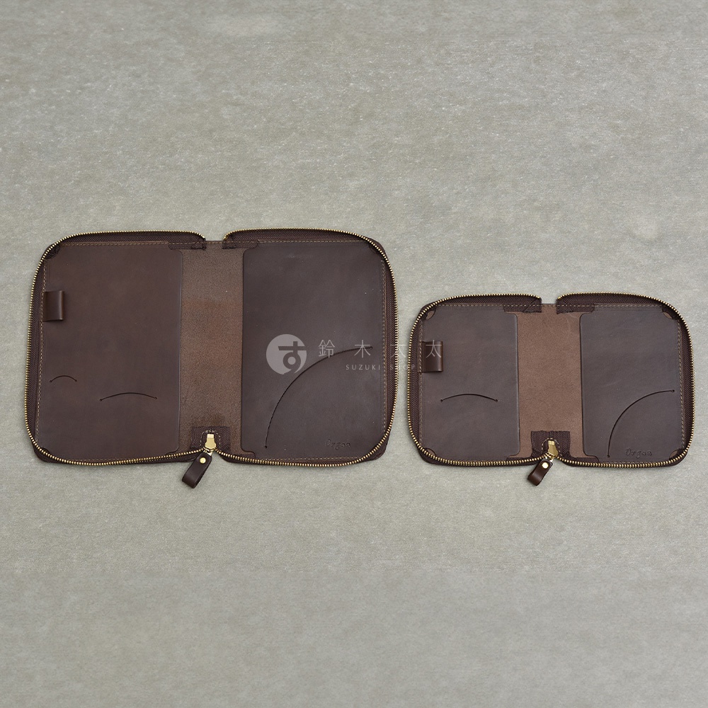 兩個深棕色皮革製的拉鍊式收納包，左邊較大，右邊較小，均攤開展示內部隔層。