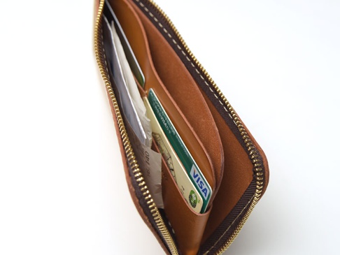 職人手作皮革L型拉鍊長夾，展現天然皮革的溫潤質感，內部分層可收納卡片與紙鈔，搭配金色拉鍊，經典實用。