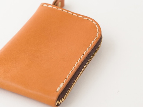 職人手作皮革分隔收納迷你錢包（KK-2），採用淺棕色真皮材質，車線為米白色，搭配深棕色拉鍊，設計簡潔實用。