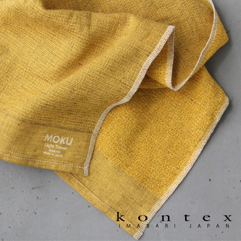 黃色 MOKU 超速乾輕薄吸水浴巾，紋理細膩，觸感柔軟，邊緣有白色縫線。